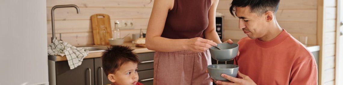 A happy family having breakfast together at home, sharing food and moments.